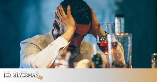 Man at a bar with a drink and his keys near his hand
